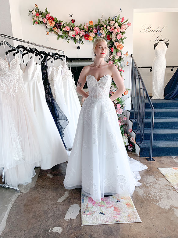 DFW bride trying on wedding dress with a private stylist
